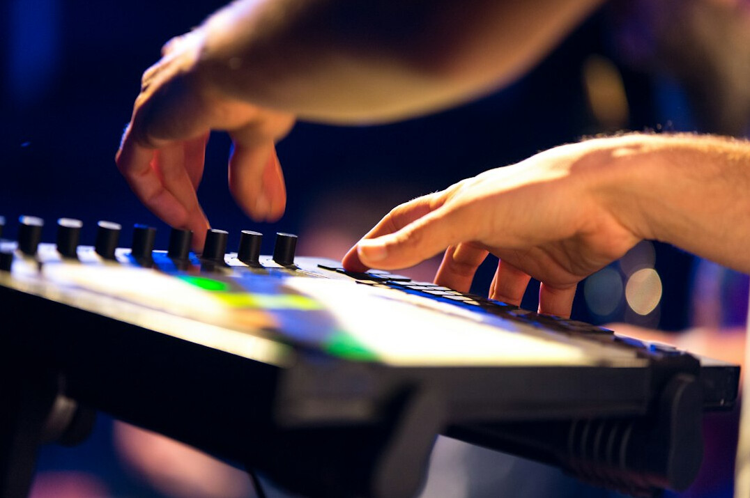 Hands typing on a laptop showing video editing software