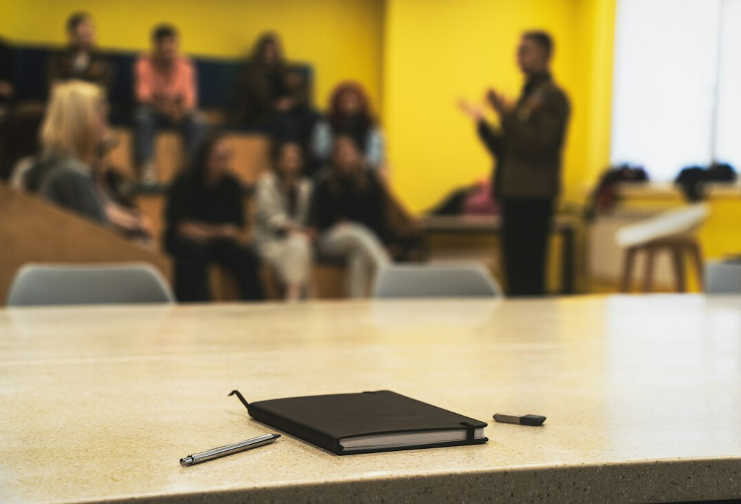 Students learning video editing in a training classroom